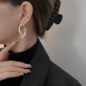 Curved cross earrings